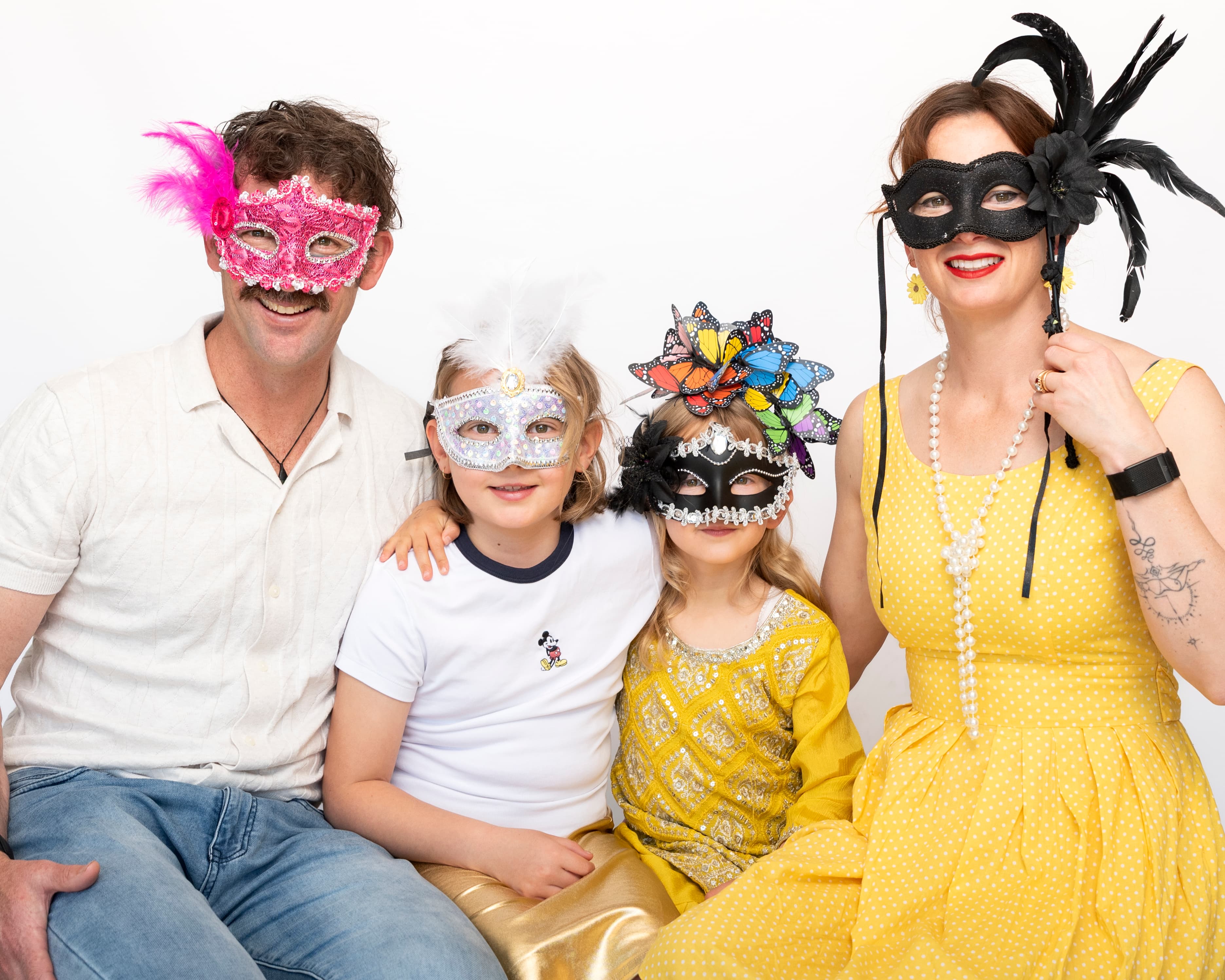 Belinda with family wearing masquerade masks