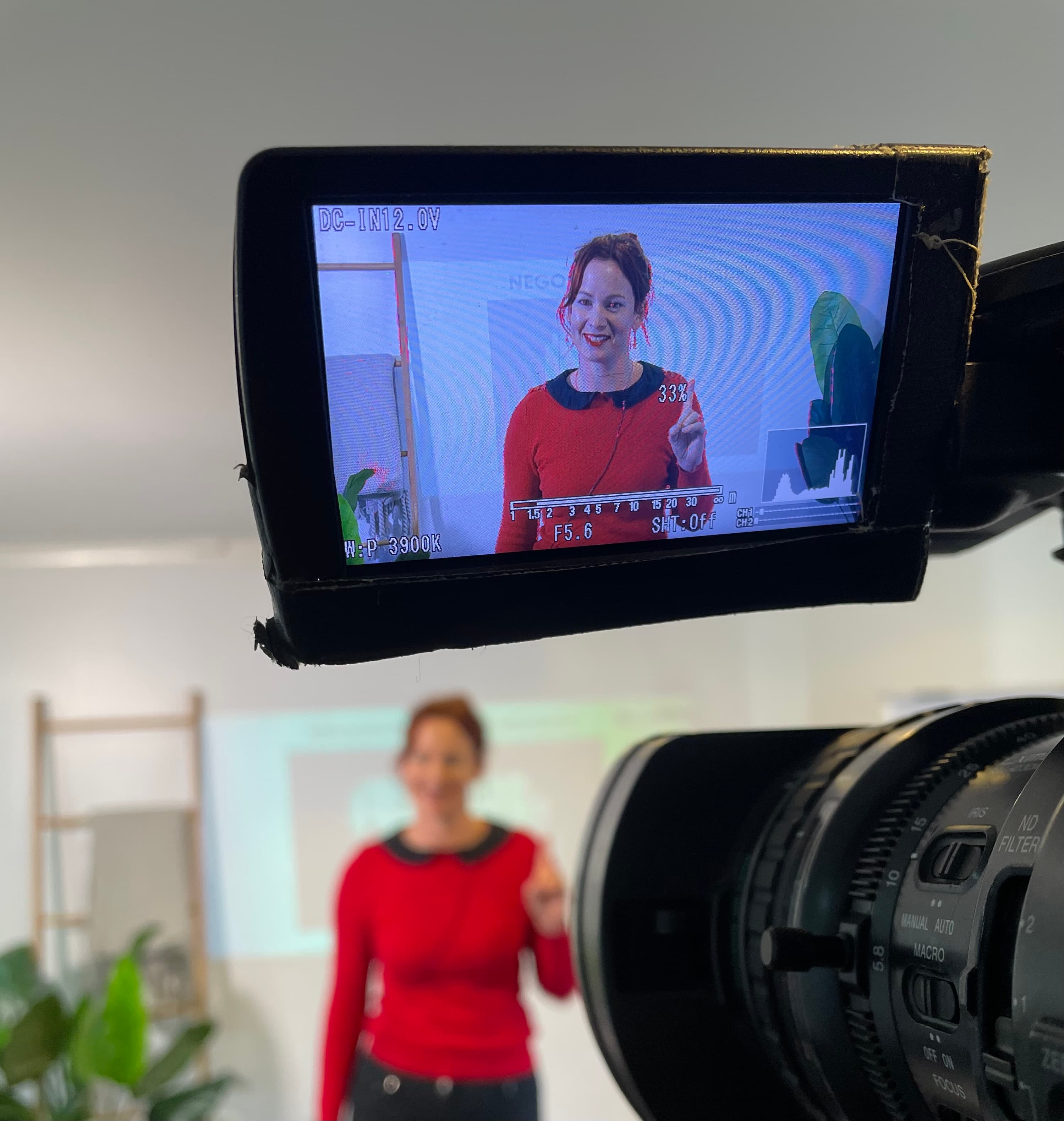 Belinda being filmed through camera viewfinder