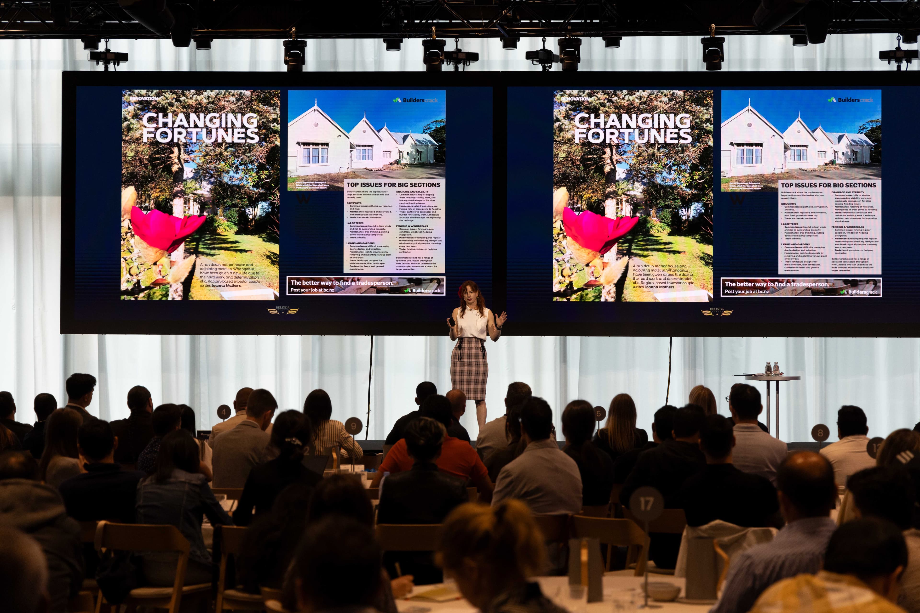 Belinda presenting on stage to a large audience