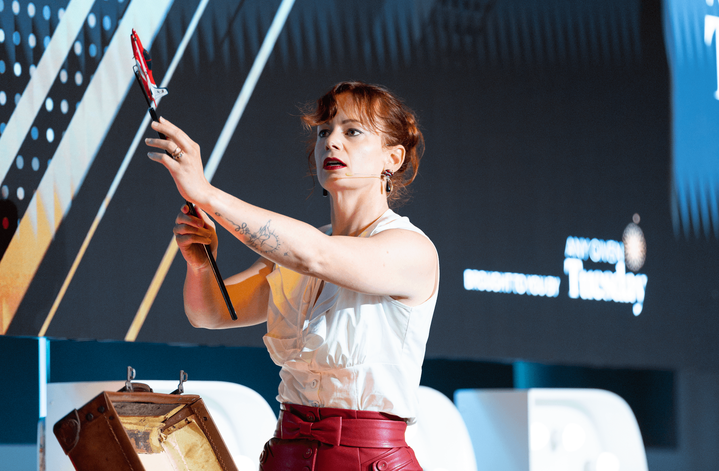 Belinda on stage with prop during keynote